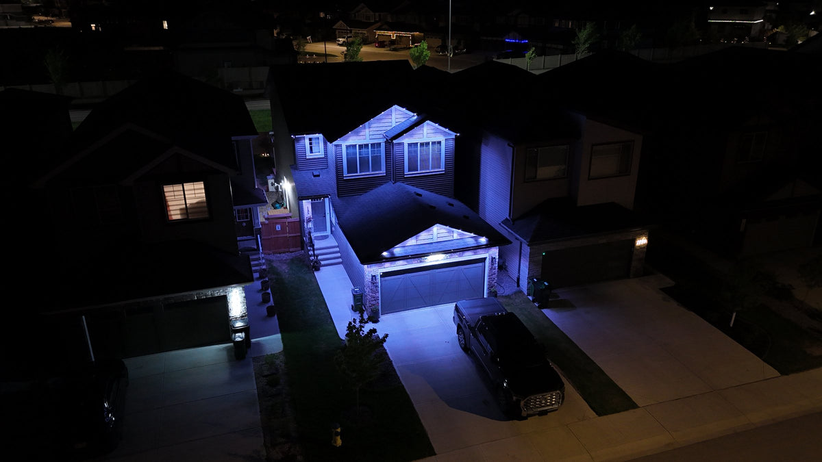 Drone shot of a home lit blue with Horizon permanent lights